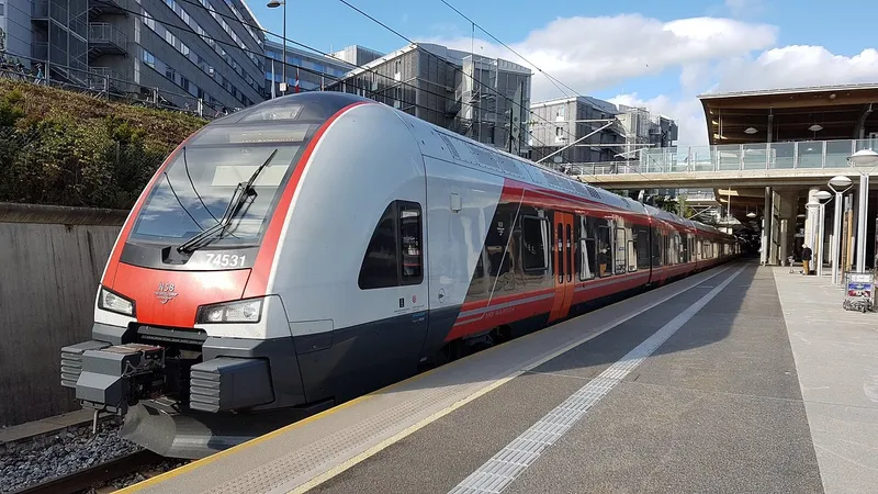 Tren Vy rojo y blanco en el andén de una estación