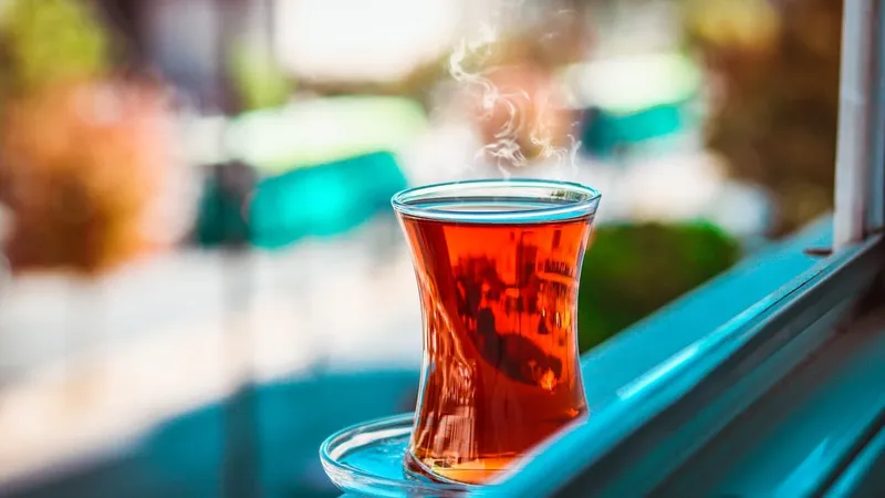 Glass of Turkish tea beside a train window